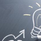 Drawing light bulb on blackboard