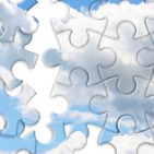 pieces of a jigsaw puzzle forming clouds