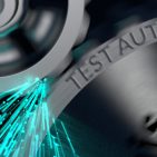 test automation engraved on metallic gears with blue sparks shoot off