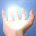on a blue background an open palm holds a sun burst