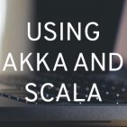 The words "Using Akka and Scala" super-imposed over the photo of a laptop